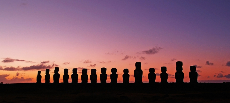 A row of Moai statues on Easter Island against a pink and purple sky, What is the oldest joke in the world
